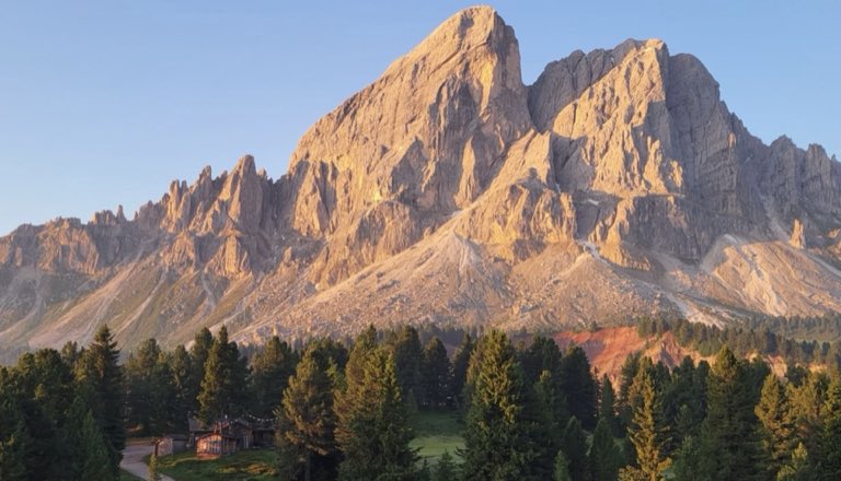Dolomite peaks at golden hour above a forested valley
